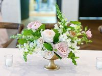 Lush garden style centerpieces of neutral and blush garden roses, ranunculus, snap dragon and fresh greenery by Leaf + Petal NOLA for a wedding at Il Mercato in New Orleans