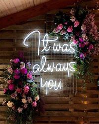 small and intimate floral wedding ideas with neon signs for some modernity