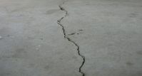Don't be intimidated by garage floor repairs. Save money by learning how easy it is to repair cracks and pitting in your concrete floor.