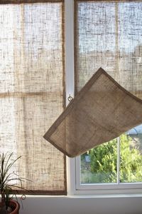 Here's how to make easy DIY burlap window shades with goods from the hardware store—all for less than $20 each.