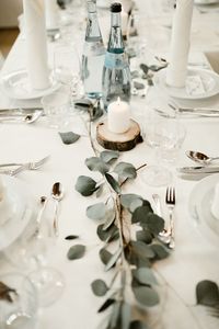 Elegant + minimalist wedding reception table with greenery, rustic details, and candles | Image by Kaley from Kansas