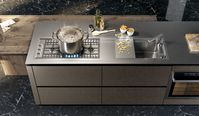 Base cabinets fronts: Burnished bronze lacquered brushed metal effect and earth grey stained | tall cabinets fronts and above columns: Burnished bronze lacquered brushed metal effect and black aluminum frame smoked glass | Upper cabinets fronts: Earth grey stained | Snack table: Earth grey stained | Worktop: Stainless steel | Groove and plinth: Titanium