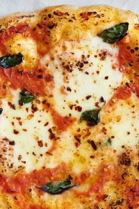 NYT Cooking: Here is the archetype of a thin-crust pizza pie, a pizza margherita adorned simply in the colors of the Italian flag: green from basil, white from mozzarella, red from tomato sauce. This pizza is adapted from the recipe used by the staff at Roberta’s restaurant in Brooklyn, who make their tomato sauce simply by whizzing together canned tomatoes, a drizzle of olive oil ...