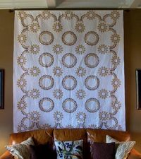 Hang a quilt from the ceiling behind your couch for instant art. I hope to one day hang a quilt behind my bed in lieu of a headboard.