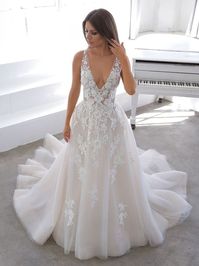Romantic and timeless aline wedding dress with lace appliques throughout, whimsical organza skirt, V neckline and illusion bodice. #MissRubyBride Available to try on in store in size 24