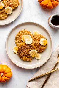 These Fluffy Pumpkin Pancakes are moist, buttery, and perfectly spiced for fall. The ultimate wholesome breakfast treat! Gluten-Free & Oil-Free.