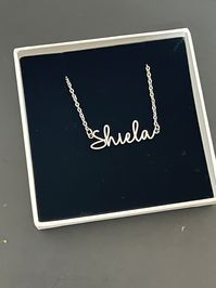 This necklace features a Dainty Sterling Silver Personalized Name Necklace with Chain. You can have your own name or word made. All carving will be made in the font as the photo. This name necklace and chain are dainty. #daintynecklace #chainnecklace #silvernecklace #cutenecklace #jewellery