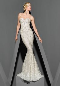 Victor Harper Couture VHC282 Strapless embroidered and beaded tulle gown with lace hem, tiny bows on bodice. Silhouette: Sheath Neckline: Sweetheart Waist: Dropped Gown Length: Floor Sleeve Style: Strapless Fabric: Embroidered tulle Embellishments: Lace Color: Crystal/Nude Size: 0 - 20 Price: $$$$$