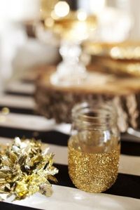 half dipped mason jar in glitter.