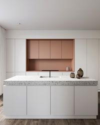 Cuisine éclectique avec armoires roses et comptoir de terrazzo