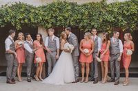 Coral bridesmaid dresses and gray suits for the groomsmen