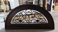 This gorgeous wrought iron transom was custom designed to match the door. It is in our shop- ready to be packaged and shipped to the buyer! custom homes. custom door. dream home. iron doors. transom. iron transom. home building. home remodel.