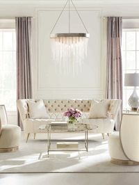 This button-tufted beauty offers inimitable style. Its shapely silhouette features a decorative inset metal frame with an open pattern of connecting circles-the symbol of no beginning and no end. A Whisper of Gold metal finish highlights its one-of-a-kind frame, and complements the dressy textured pure ivory fabric of its tufted, upholstered back and seat. With perfect proportions, the sofa is finished with fashion-inspired legs.