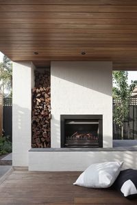 An outdoor fireplace with built-in firewood storage. When Stephen Mendel—co-owner of Australian furniture company Globe West—and his wife bought a rundown 1960s house in the Melbourne suburb of Caulfield, the design-savvy pair knew what they wanted. Experienced remodelers, they had previously worked with Bower Architecture, and turned to the designers to bring their program to life once again.
