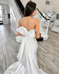 Say "hello," to this unabashedly chic and feminine bridal gown! This unique strapless satin mermaid wedding gown is right for you if you are looking for a classy statement. Just look at that optional bow! 😍 Click through for all the deets! #satinweddingdress #mermaidbridalgown #Mitchellmaggiesottero #statementbow #maggiesottero