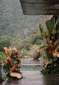 Paradise is a place on earth. We believe that after seeing this modern elopement with boho jungalow vibes at a luxe Costa Rican villa! From the sleek halter wedding dress to the monstera leaf wedding decor to the rattan candle hurricanes, we have a feeling this contemporary take on tropical weddings will have couples flocking to rainforests for their destination nuptials in no time.