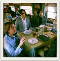 Wes Anderson on the set of his movie The Darjeeling Limited with Adrien Brody, Jason Schwartzman, and (barely pictured) Owen Wilson.