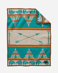 Tuck Them In And Tell A Story With A Soft Wool Baby Blanket Made In America. This Design Evokes A Peaceful Night Of Telling Tales, With The People Of The Tribe Safe And Warm In Their Tepees. Above It All Shines Bear, The Great Guardian Of The Night Skies, And A Pair Of Crossed Arrows, Symbolizing Peace And Brotherhood. Monogrammable Too! 32" X 44" Napped; Fabric Is Combed For A Softer, Thicker Feel Felt Binding Pure Virgin Wool/cotton Fabric Woven In Our American Mills Dry Clean Made In USA | ST