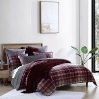 Give your bedroom a beautiful modern makeover with the UGG Beacon Comforter Set. The trendy bedding features a brushed cotton flannel plaid design with a faux fur reverse that creates a remarkably cozy oasis.