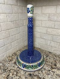 Base of the paper towel holder has a base approximately 1.5" tall and 8.5" diameter. Pattern is visible when holding a roll of paper towels. Measures 8.5" tall. Kalich