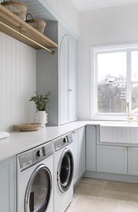A new build in the charming Brookfield area of Brisbane, this home melds the best of country interior design with coastal and luxe influences. Gorgeous classic home that screams for a holiday asap! Laundry mudroom styling: blue laundry, storage, mudroom, mudroom storage, mudroom in laundry, farmhouse sink, butlers sink, luxe laundry, gorgeous laundry, beautiful laundry, basket storage, window in the laundry. Check out more of this beautiful home by clicking the pin!