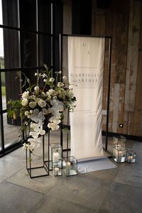Beautiful all white modern wedding florals | Beautiful modern wedding welcome sign with white roses and white orchids #weddingwelcomesign #mordernwedding #weddingflorals