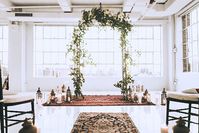 Persian rugs work also for indoor settings as we can see here. I love the foliage arch to bring the outside in.