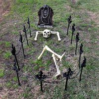 Bones in the Graveyard A bony figure sets a spooky scene in your grassy front yard. Set up a skeleton head, arms, and legs as if he's relaxing on his final resting spot. Plastic posts and a headstone