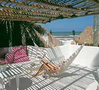 Named for the sugar cane grown in its home state of Veracruz, the Azúcar is a bohemian chic hotel overlooking the Gulf of Mexico. The hotel has 20 low-slung thatched-toof bungalows, all in an intense white-on-white colour scheme, with private terraces, each with its own locally made hammock for naps or reading sessions cooled by the sea breeze. Public spaces are mainly open-air, including the library, a spa area and a restaurant.