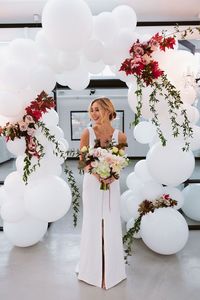 Gorgeous balloon arch. White balloons with real flowers! So beautiful for a wedding.