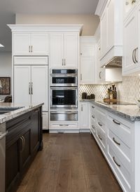 This bungalow condominium had some exceptional features such as cathedral ceilings and large windows but an awkward layout with very little storage. Non load bearing partition walls were removed to create an open concept kitchen and dining area. We widened the front foyer and relocated the laundry closet to the front of the house with lots of custom cabinets for storage.