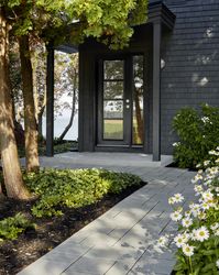 This walkway landscaping design is inspired by our Blu 80 Smooth paver. Smooth and sleek, Blu 80 mm Smooth is the perfect paver to fit any modern home's exterior. Now available in our HD2 technology for an ultra-tight poreless finish with anti-aging technology; this paver is offered in vibrant and neutral colors. It can also be installed in a permeable application and it benefits from all the de-icing salt resistance necessary for harsh winters. Check out our website to shop the look!