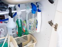 Brilliant space-saver: install a tension rod to hang your spray bottles. Genius!