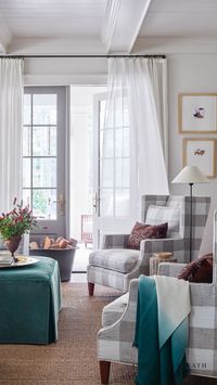 ASHLEY GILBREATH INTERIOR DESIGN: The family room takes on a more relaxed feel with splashes of color and playful patterns. Clean up is also a breeze thanks to performance fabrics and the skirted ottoman and classic buffalo chair wingback chairs. A pretty and practical family living room. architect: Brandon C. Ingram