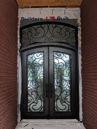 Give us a thumbs up if you think this custom, wrought iron double entry door with transom is as beautiful as we do! Newly installed and ready for the finishing touches. custom builder, custom home, homeremodel, iron doors, double doors, front door, metal door, flemmish glass, luxury home, custom door.