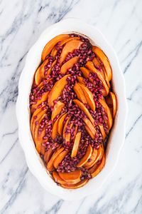 Sliced Sweet Potatoes are baked in a spiced orange maple glaze and sprinkled with juicy, bright pomegranate arils. It is a gorgeous, colorful Thanksgiving side dish that is a little bit more on the