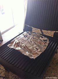 Foil grilled salmon on a george foreman (or panini maker)