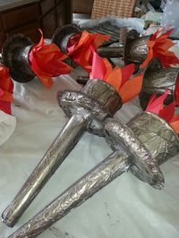 Torches for VBS. Used paper towel tube, paper plate, and top half of very large cup. Wrapped all in foil, hot glued together, then painted with sponge brush and acrylic craft paint (dabbed black, Brown and gold onto brush from paper plate palette). Stuff with foil, viola! Then I cut strips of card board, did same foil/paint treatment. Will attach a strip to wall in a half circle and set torch in!
