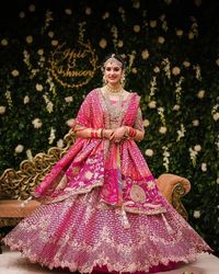 Gorgeous Pink Bridal Lehenga decked up with subtle shimmer and paired with gold jewels and natural, dewy makeup, this bride loos ethereal on her big day. #pinklehenga #lehengainspiration #pinkbridallehenga
