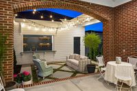 By keeping the footprint of the house smaller, the FHB House team created a courtyard between the house and alley-loaded garage in the rear of the lot. This courtyard functions as an outdoor family room and entertainment space - Fine Homebuilding #HomeDecor #Design #Courtyard #SmallYard #YardDesign #GarageBar #FamilyRoom #YardPrivacy