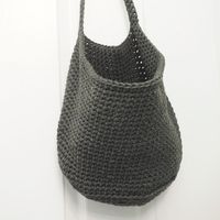 These hanging storage baskets hang on the wall so they don’t take up space on your floor. This crochet basket is very minimalist in style. #CrochetBasket #CrochetBasketPattern #FreeCrochetPattern