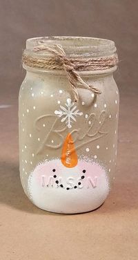 This mason jar candle holder features an adorable snowman catching a snowflake on the tip of his nose. A perfect addition to your holiday decor: