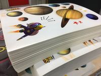 A clear sticker sheet featuring some fun peel off designs of planets and a rocket bird, of course!