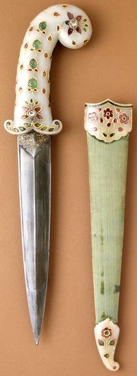 Indian dagger, Mughal empire, circa 1675-1700 (sheath fittings, circa 1800), white nephrite jade hilt and sheath fittings inlaid with foiled rubies, emeralds, and diamonds set in gold; steel blade; velvet covered wooden sheath overall: 16 7/8 x 3 x 1 in. (42.8625 x 7.62 x 2.54 cm) Sheath: 11 1/4 in. Dagger: 14 5/8 x 3 x 1 in. The Los Angeles County Museum of Art (LACMA).