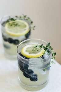 Limoncello prosecco with blueberries and thyme. The perfect summer cocktail.