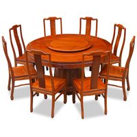 Featuring exquisite Chinese key motif and longevity symbols, this Ming (1368-1644) style round dining table set is crafted from solid rosewood using traditional joinery techniques. The table comes with one removable lazy susan for your dining needs. Hand applied natural finish enhances the beauty of the rosewood grain and rounds out its quiet beauty. The set comes with eight side chairs.