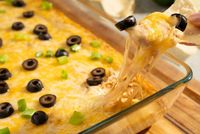 Don't let the name fool you: Texas Trash Dip is a real treasure! This creamy and hearty appetizer is filled with refried beans, spicy chiles, and melty cheese for a delectable dip that positively sizzles with satisfaction. Texas Trash Dip gets the rodeo started with plenty of Southwest flavor from taco seasoning and black olives for a unique twang of tang. This dish tends to go fast, so make sure to make two and bring plenty of tortilla chips for dipping!