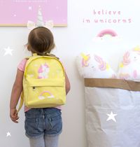 little girl with unicorn backpack