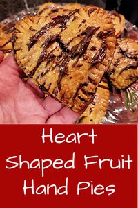Heart Shaped Fruit Hand Pies - A Romantic Dessert. Flaky, homemade pie pastry in the shape of a heart with a fruit filling topped with chocolate drizzle. #handpie #heart #fruitpie #fruithandpie via @BooksCooksLooks