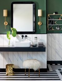 Play with lighting in your bathroom. Place it near a reflective surface such as a mirror to increase the amount of light streaming into the space. You can also make a décor statement with your choice of light. Image courtesy, CB2